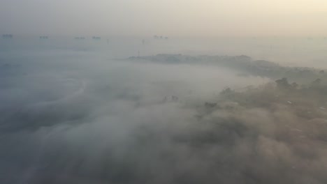 Misty Sunrise Over City and Landscape
