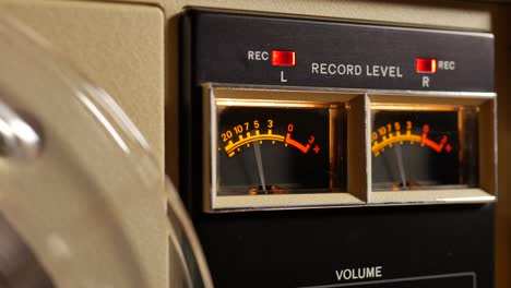 analog vu meter of a vintage tape recorder machine while recording