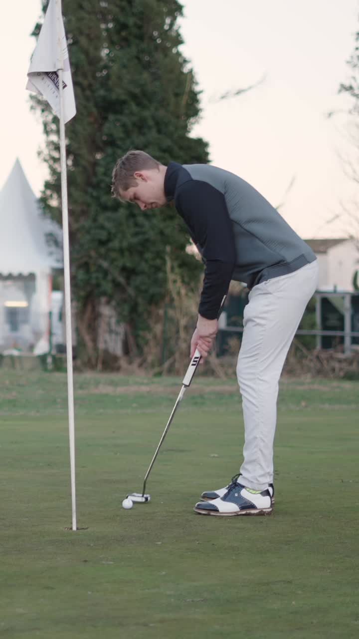 Golfer putting on green