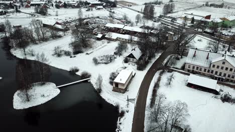 slow drone shot over lake next to small village
