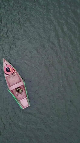 small wooden boat on a calm body of water