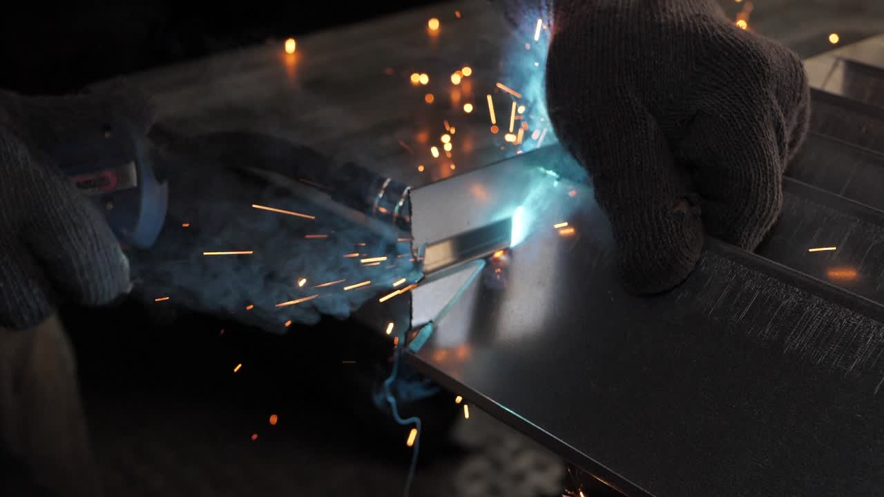 Close-up work with metal steel and iron using a welding machine