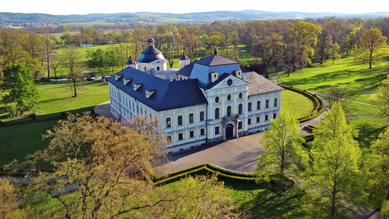 Drone establishing front dolly of historic Castle Kravare and lush autumn surroundings in MoravianSilesian region Czech Republic