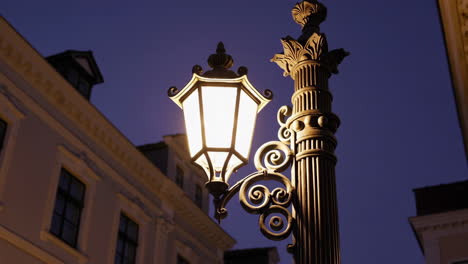 ornate street lamp glowing at twilight