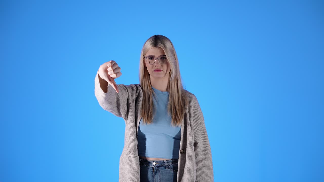 Caucasian Blonde woman Complain Denying Idea thumbs down of her hand Studio Shot