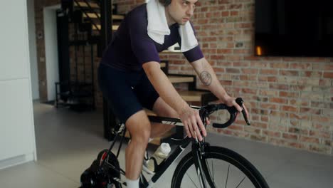 man doing indoor cycling workout at home