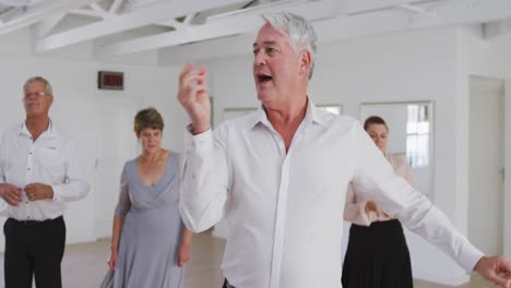 caucasian senior couple spending time together dancing in a ballroom