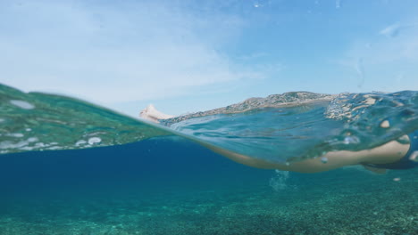 athlete swimming backstroke in the ocean