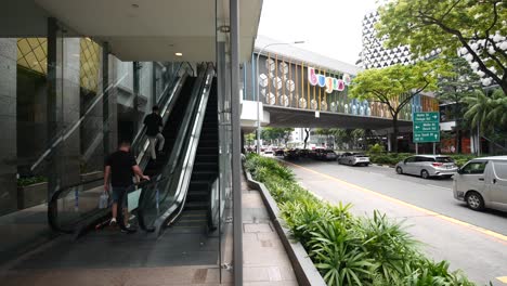 singapore street scene with escalator and bus