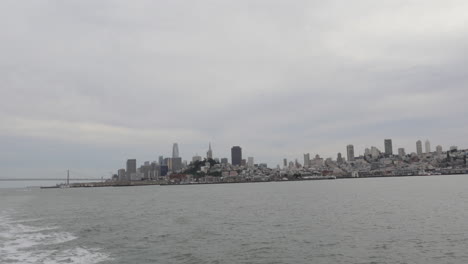 city of san francisco skyline and iconic bay bridge seen during a scenic bay cruise in california, usa