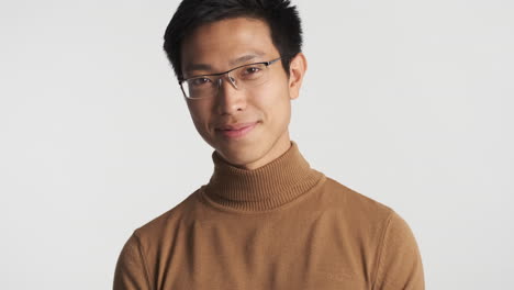 asian man in eyeglasses looking at the camera.