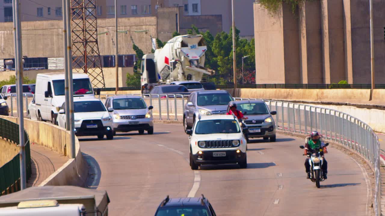 Motorbikes weave, swift and sly, through the city traffic, they fly by