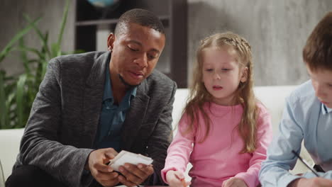 english tutor shows cards with letters teaching children