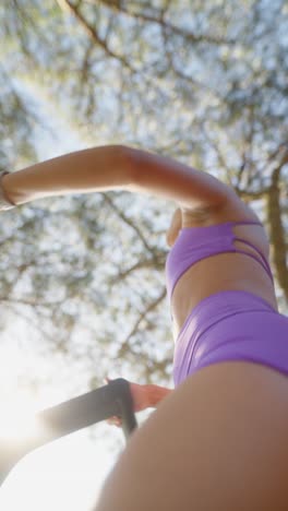woman in purple activewear exercising outdoors