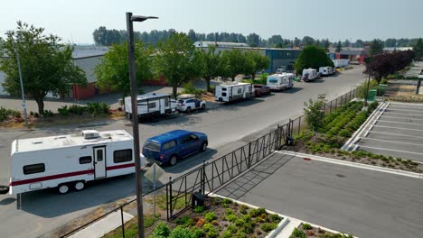 Caravan-Trailer-Towed-Behind-A-Blue-Car-At-Rest-Area-In-Mission,-BC,-Canada