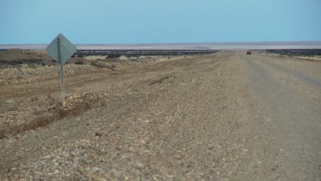 a distant car on a lonely road