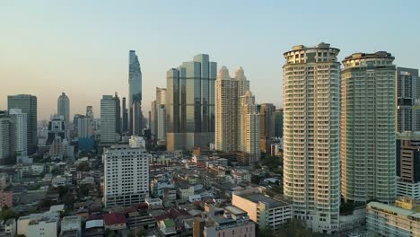 bangkok skyline with clear blue sky, aerial dolly left