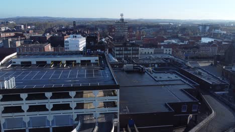overhead aerial view above city multi storey car park quiet british urban public streets at sunrise push in