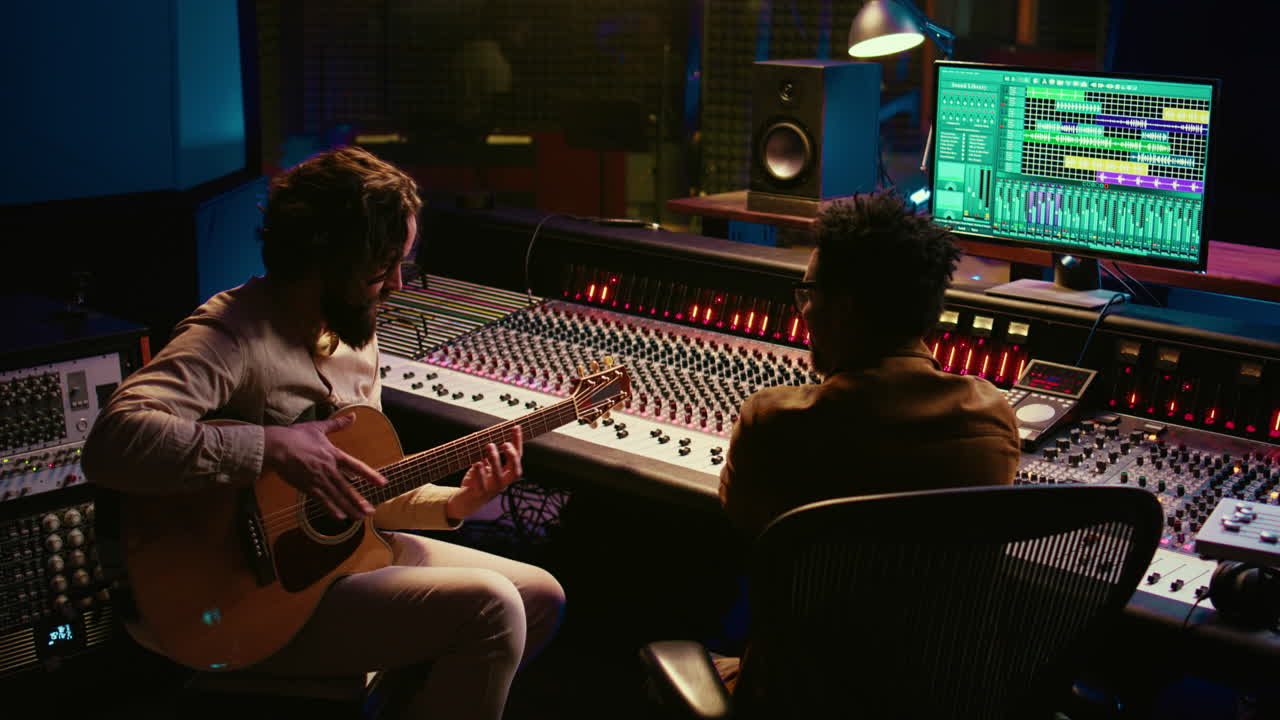 Rockstar recording music on his guitar in professional studio
