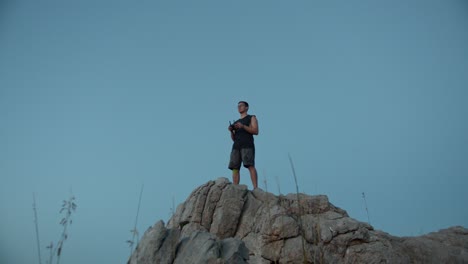 aircraft pilot on top of the hill controlling the drone to take some pictures