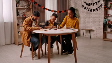 family making halloween decorations together