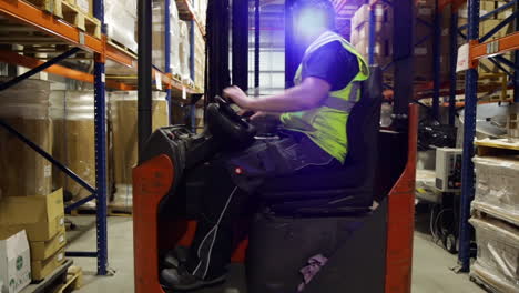 forklift driver driving a pallet in a warehouse