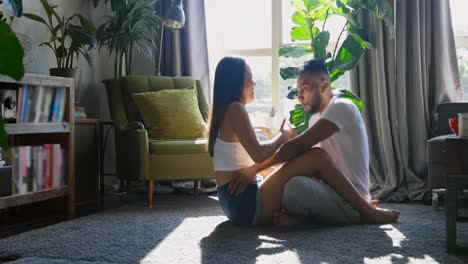 side view of young asian couple having fun together in living room at home 4k