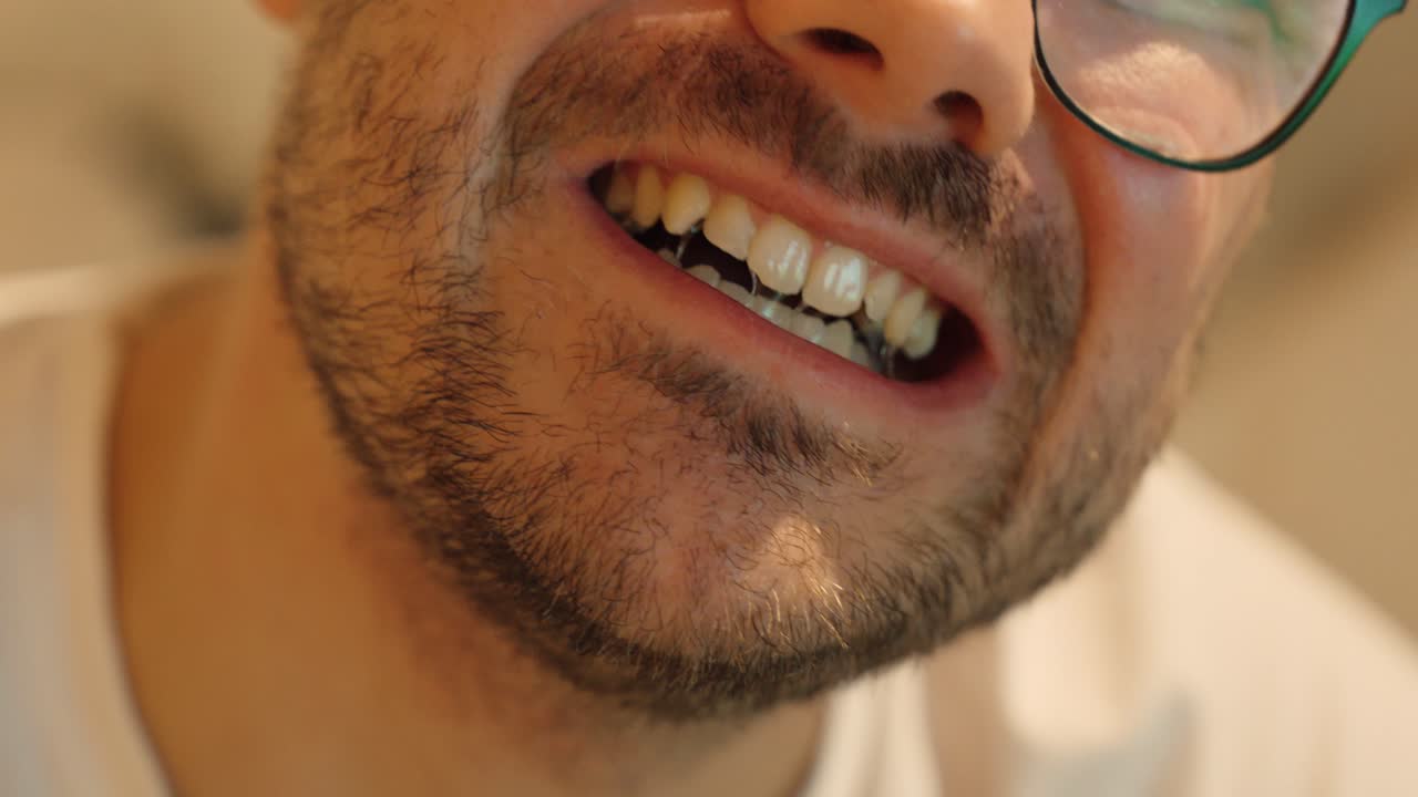 Close-up of a man pulling out a beard hair in discomfort. Concept for stress habits, skin irritation, grooming, or beard care issues