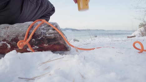 Man-Stood-Up-To-Pick-Up-The-Teapot-To-Pour-Hot-Water-On-Camping-Mug