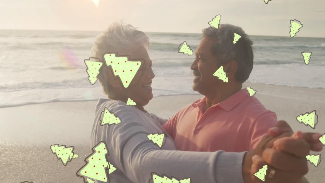 animación de iconos de pan de jengibre sobre una pareja biracial en la playa.