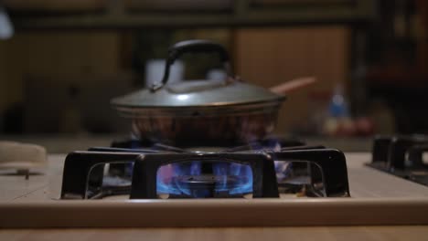 lighting-propane-burner-on-dirty-stovetop-in-trailer-park-home