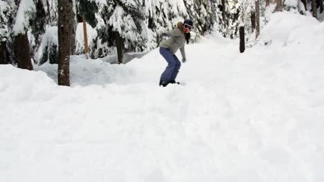 Woman-snowboarding-through-forest-4k