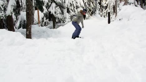 woman snowboarding through forest 4k