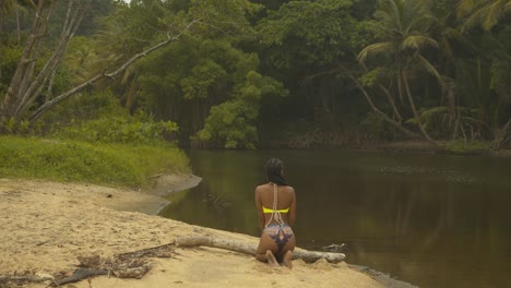 sexy model pose by the riverside on a caribbean island