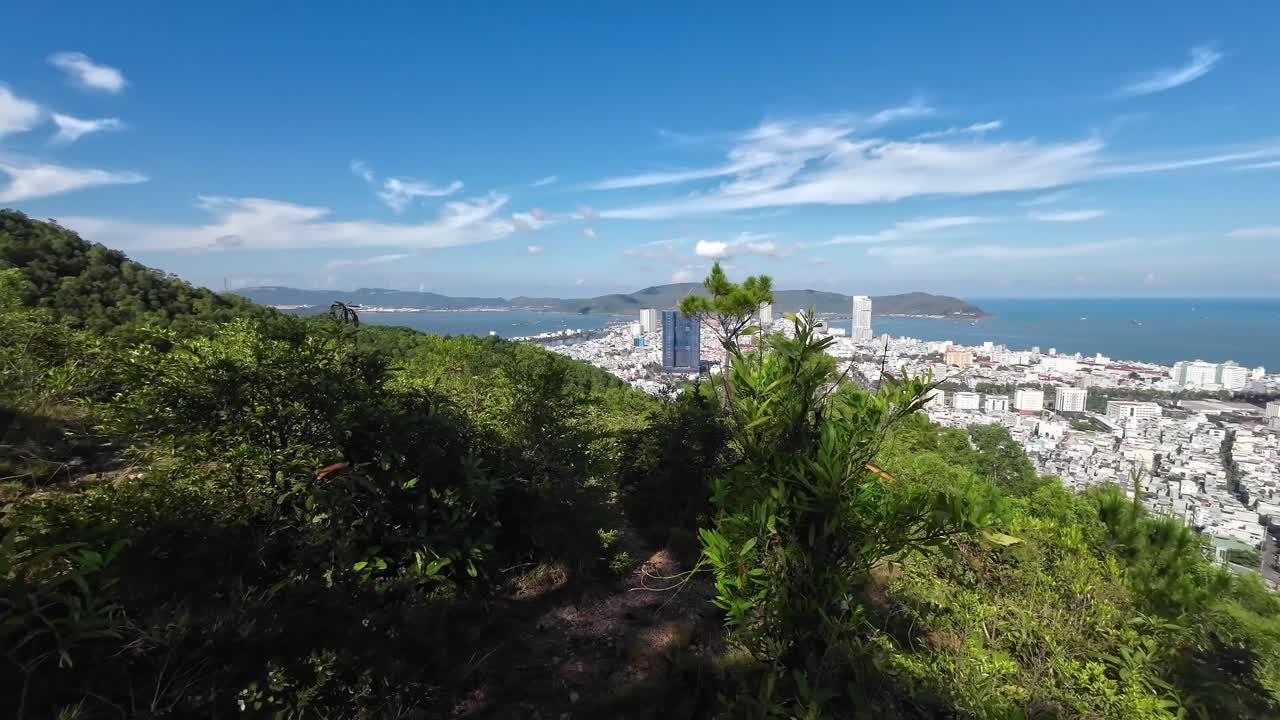 Beautiful landscape footage showing panoramic view of Quy Nhon city and coastline from Ba Hoa mountain peak in Binh Dinh Vietnam with clear sky and natural scenery