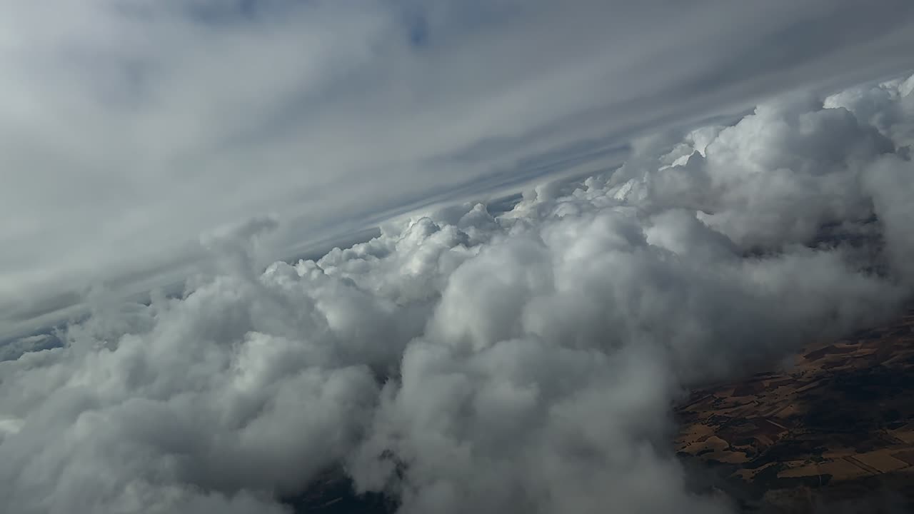 POV Flying Through Layers of Cottony Clouds in a Right Turn. Footage Taken From an Airplane Cockpit