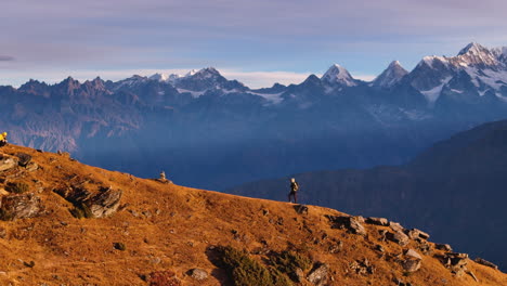 Drone-shot-of-tourist-trekking-in-ridges-landscape-Nepal-Everest-Mountain-range-at-PikeyPeak-4K