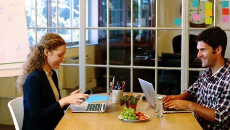 male and female business executive working together