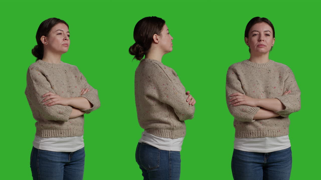 Woman posing in sweater and jeans on green screen
