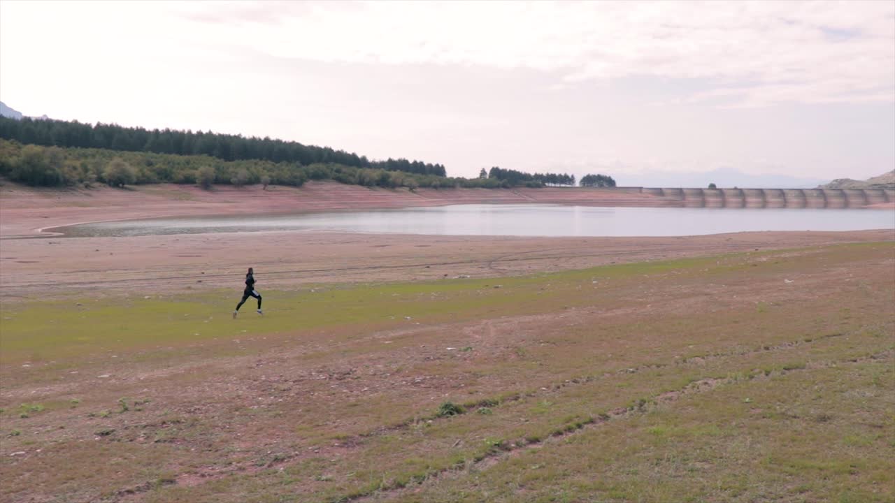 작은 호수 슬로모션의 해변에서 달리는 선수