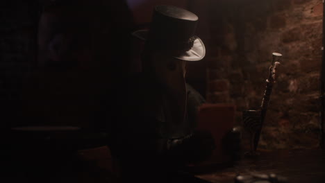 plague doctor in a dark restaurant