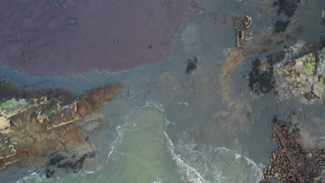 aerial footage top down moving towards the shore over the beach and the admiral von tromp wreck, saltwick bay, yorkshire