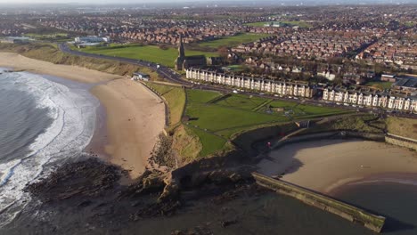drone revealing tynemouth longsands beach and cullercoats beach on north tyneside coast on sunny spring morning