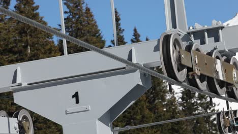 close-up of gondola ski chair on cable car mechanism with wheels and steel rope