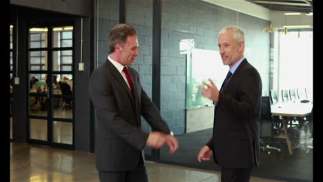 businessmen handshaking and talking