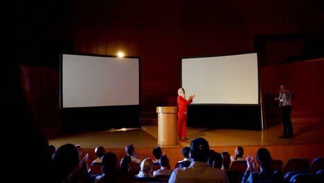 Mature-Caucasian-businessman-enters-on-stage-and-shaking-hand-with-businesswoman-4k