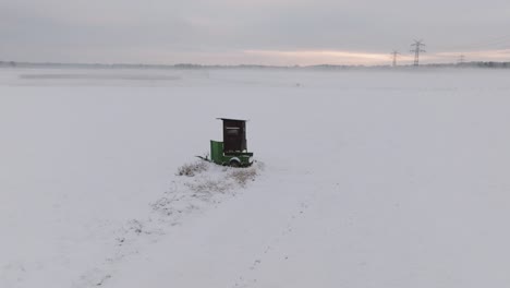 aerial shot of a snowy field with deer stand in northern germany