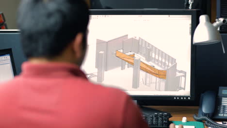 arquitecto modelando un edificio en su computadora