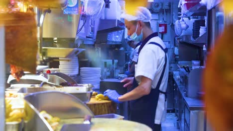 chef cooking in a bustling kitchen environment