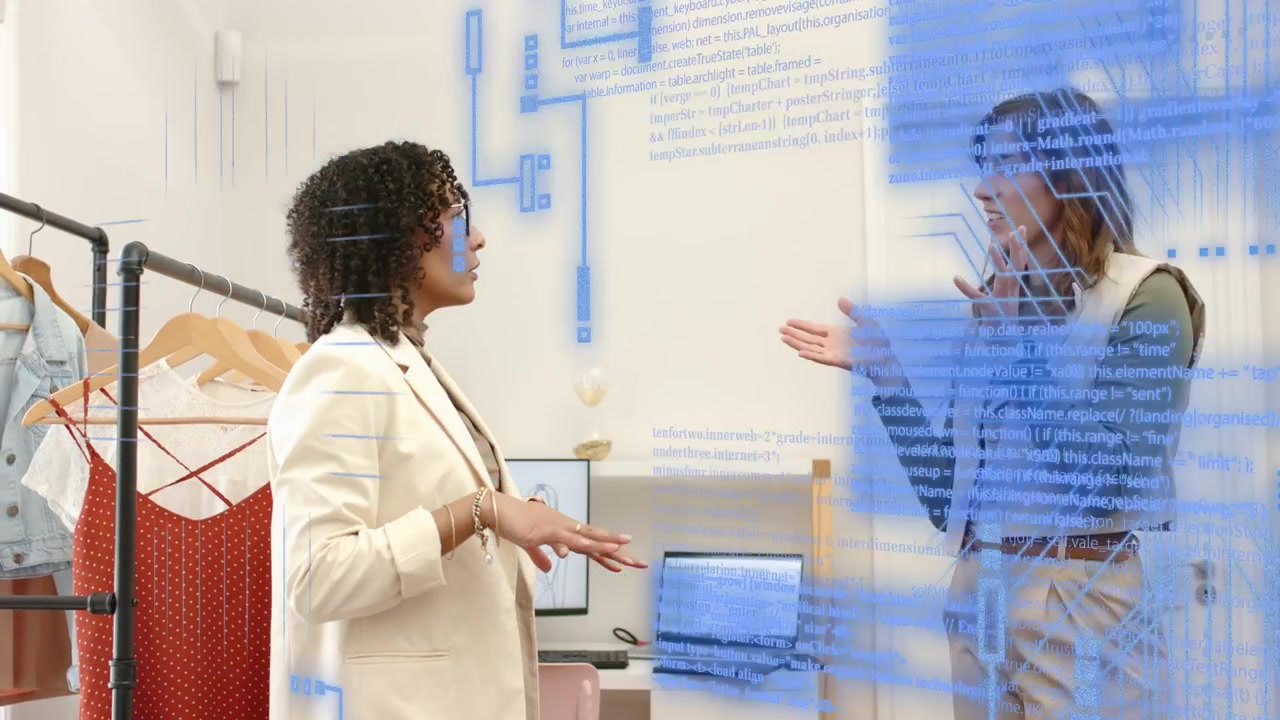 Two partners gesturing in boutique, left motion starting circuit overlay expanding, guiding design